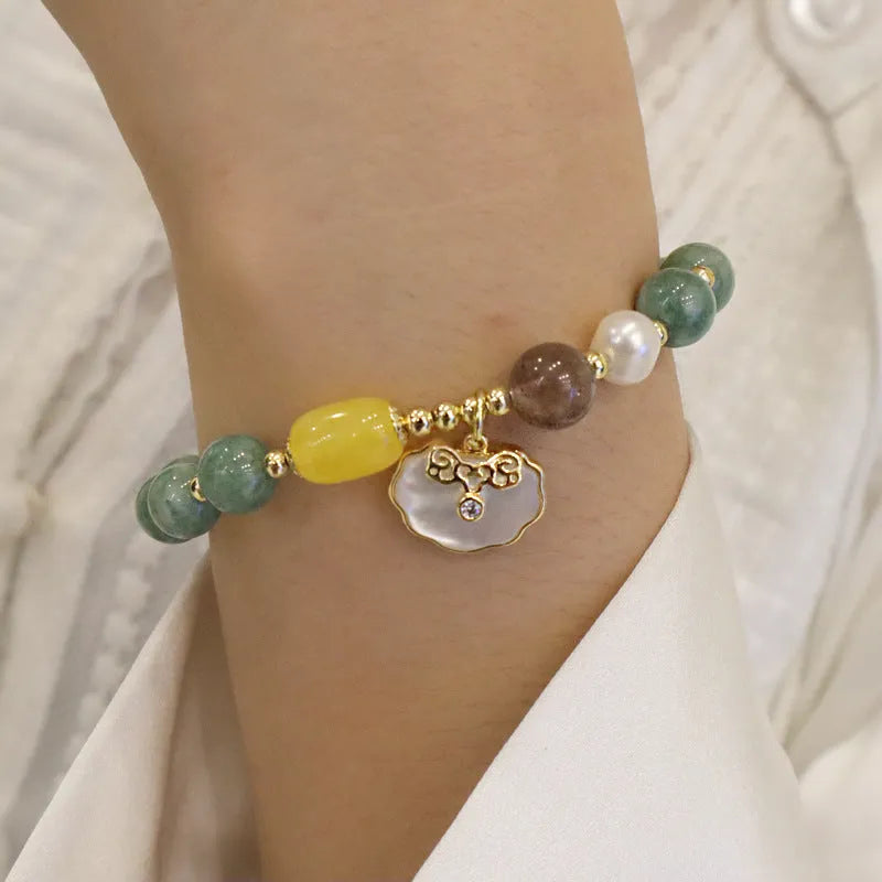 Adjustable green jade bead bracelet with a natural shell clasp fastening.