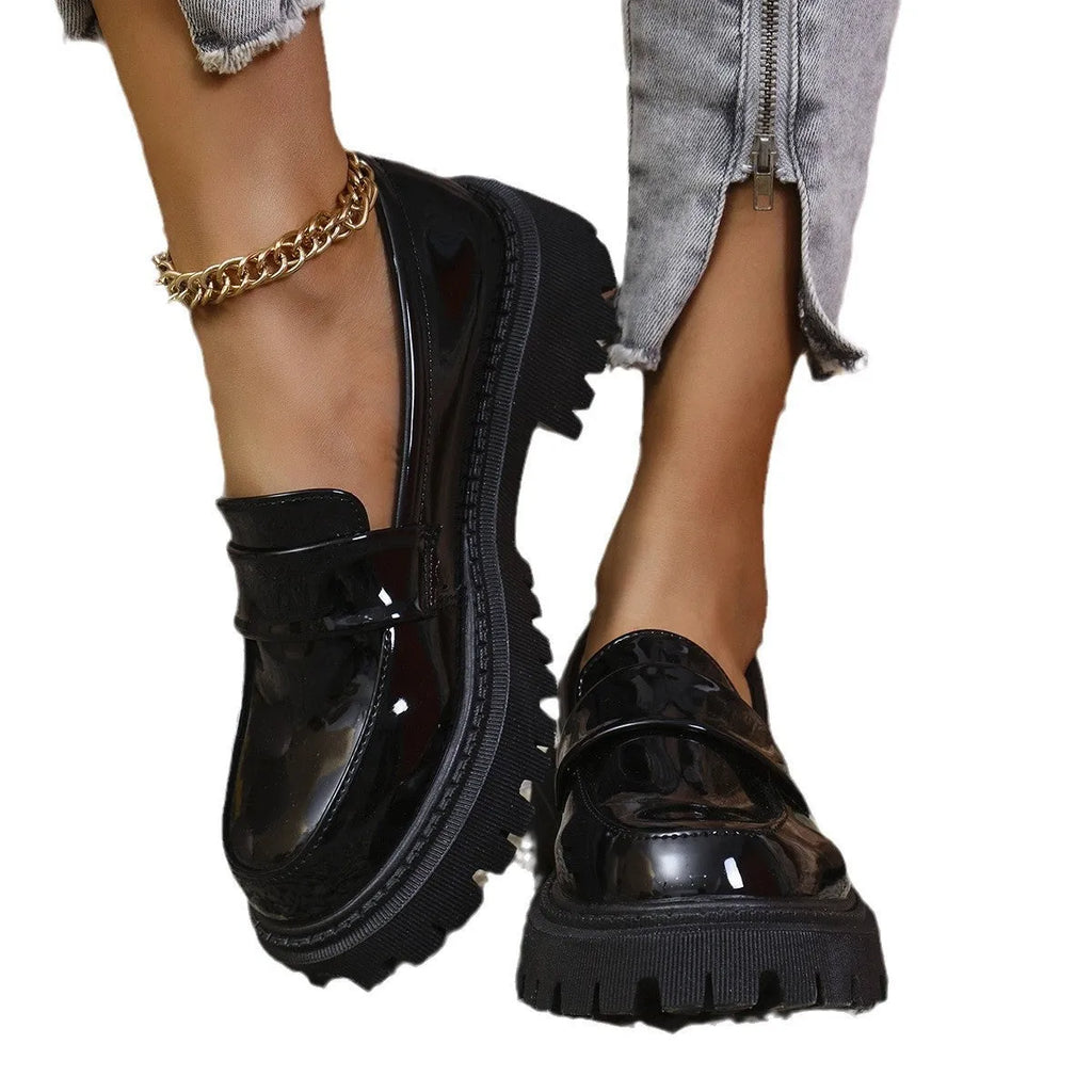 Plus size women's black slip-on loafers with a chunky platform heel and rubber sole