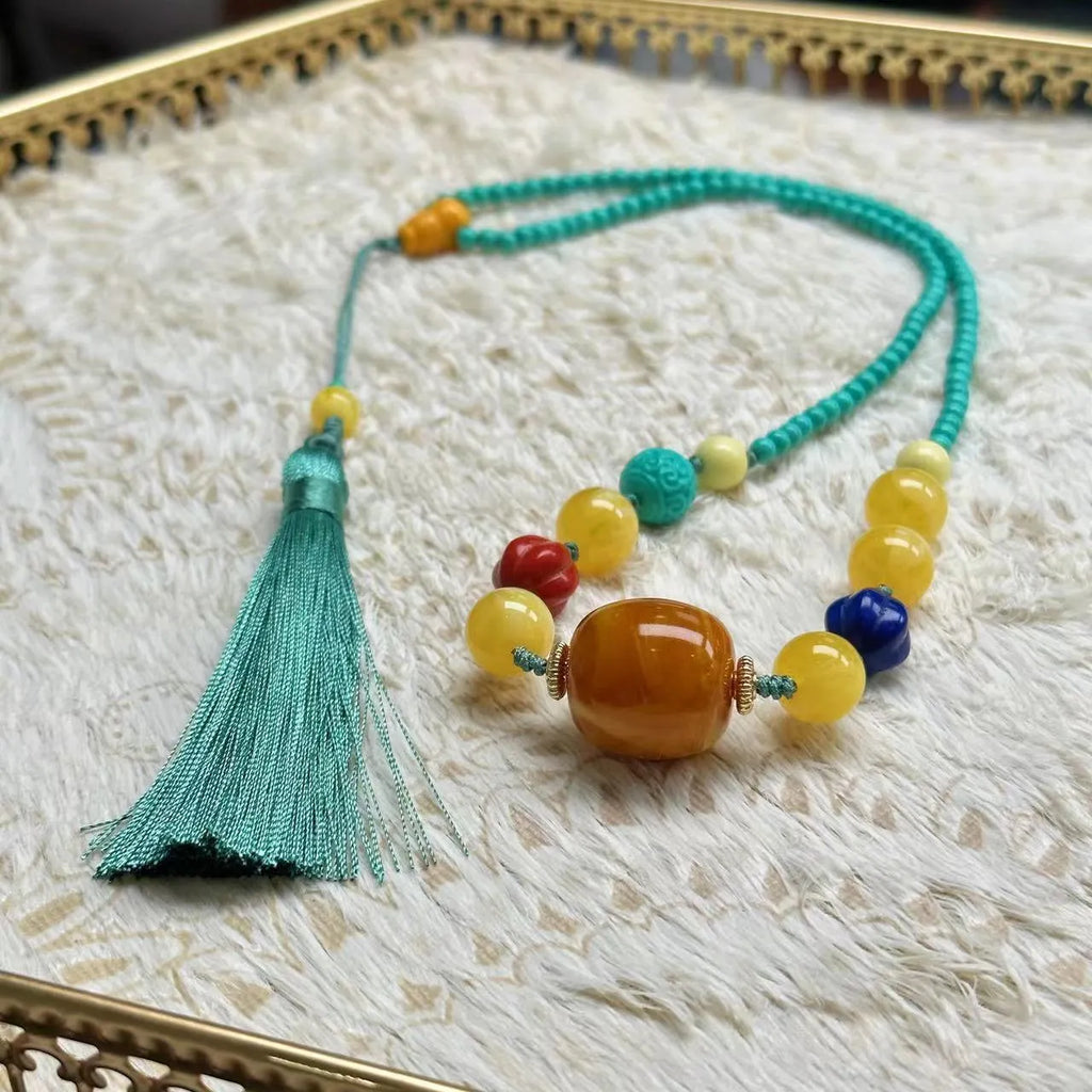 Turquoise mesh flower lucky pendant necklace on a ball bead chain, showing hand-woven detail.