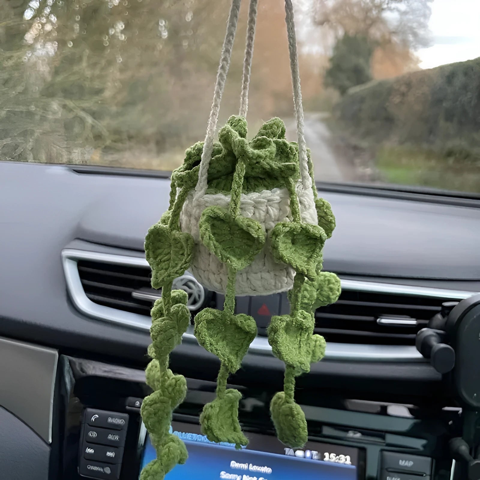 Green and white knitted wool car plant decoration with plastic base and hanging rope