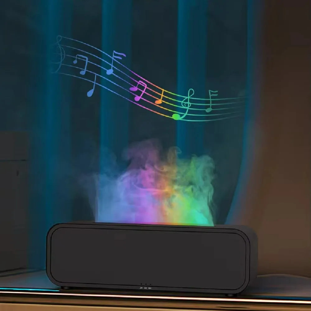 Black aroma diffuser with colour-changing flame light effect and remote control on a table.