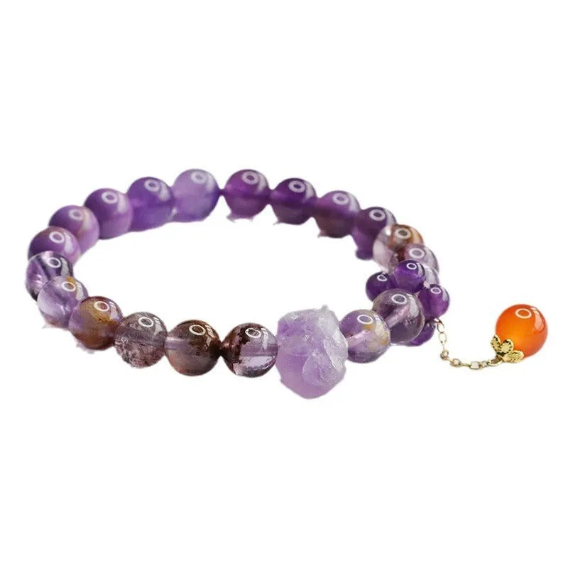 Natural nine purple amethyst and red agate multi-treasure crystal bracelet on wrist.