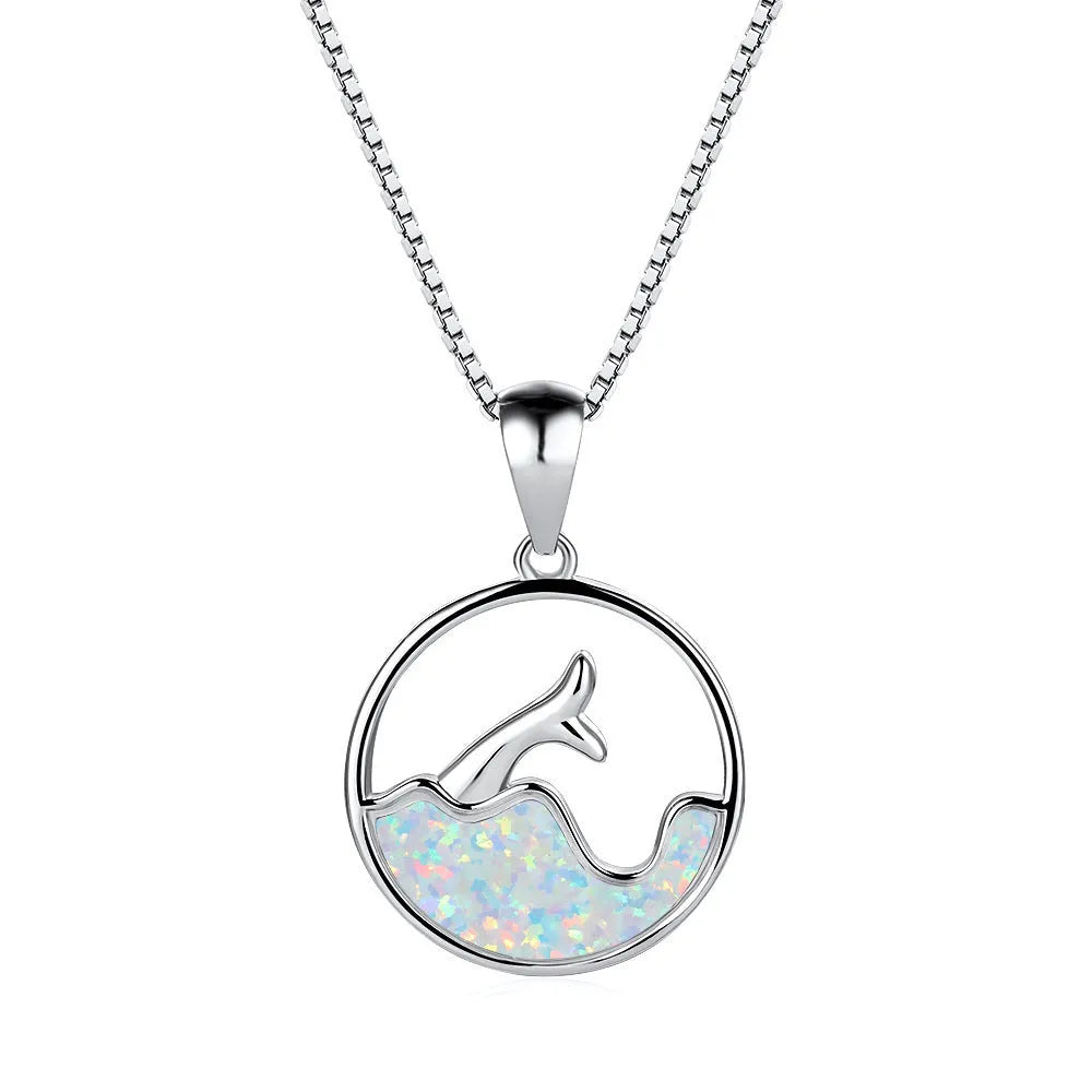 White gold colour electroplated necklace with a round sea fishtail pendant featuring a blue opal stone.