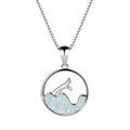 White gold colour electroplated necklace with a round sea fishtail pendant featuring a blue opal stone.