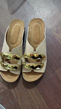 Women's white Roman style platform sandals with metal detail on a flat rubber sole.