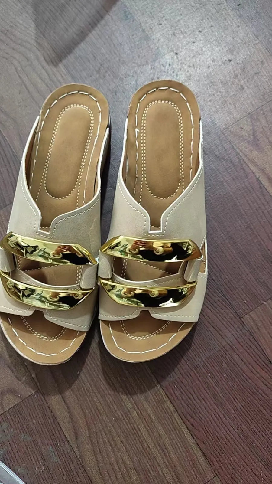 Women's white Roman style platform sandals with metal detail on a flat rubber sole.