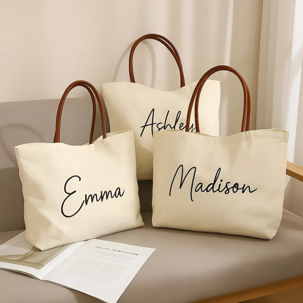 Beige white canvas tote bag with adjustable cotton handles showing reinforced bottom stitching.