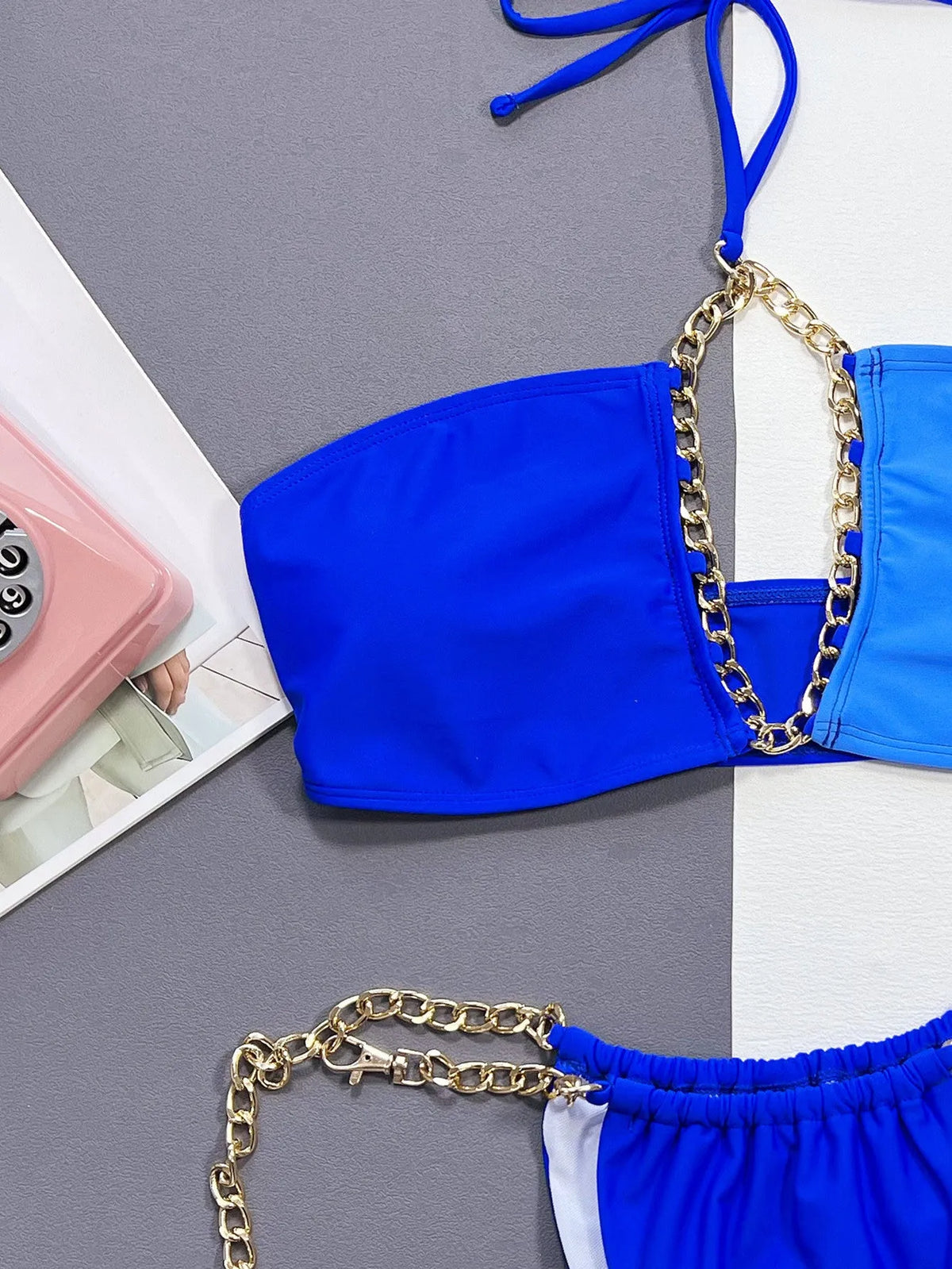 Blue solid colour women's bikini swimsuit with split style design on mannequin