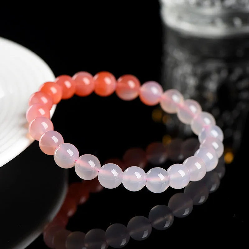 Natural gradient Yanyuan agate bracelet with geometric beads on a wrist, showing colour variation.