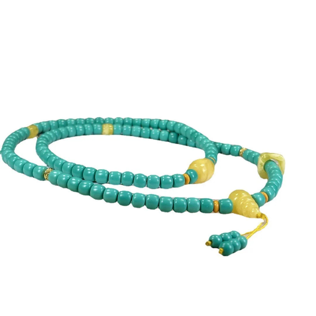 Turquoise mesh flower lucky pendant necklace on a ball bead chain, showing hand-woven detail.