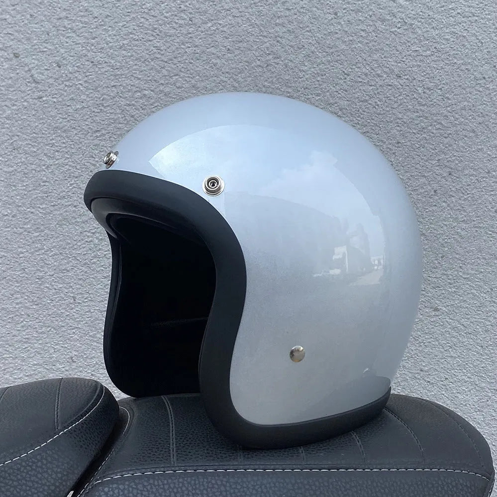 Retro-style half-shell motorcycle helmet in fibreglass, shown in a cement grey colour option.