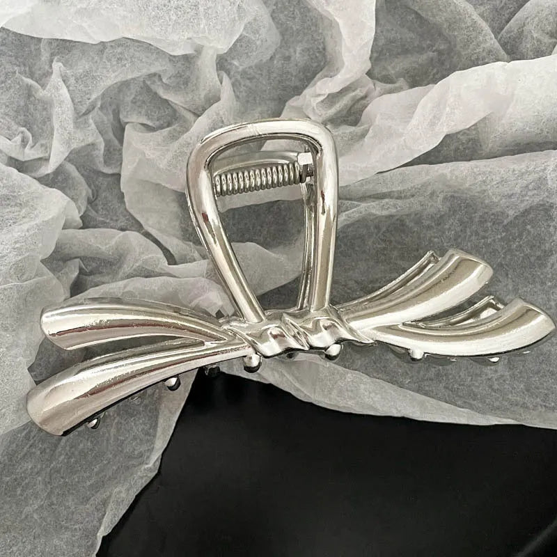 Silver metal hair clips collection with various Korean style designs including bows, pearls, and wave patterns
