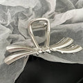 Silver metal hair clips collection with various Korean style designs including bows, pearls, and wave patterns