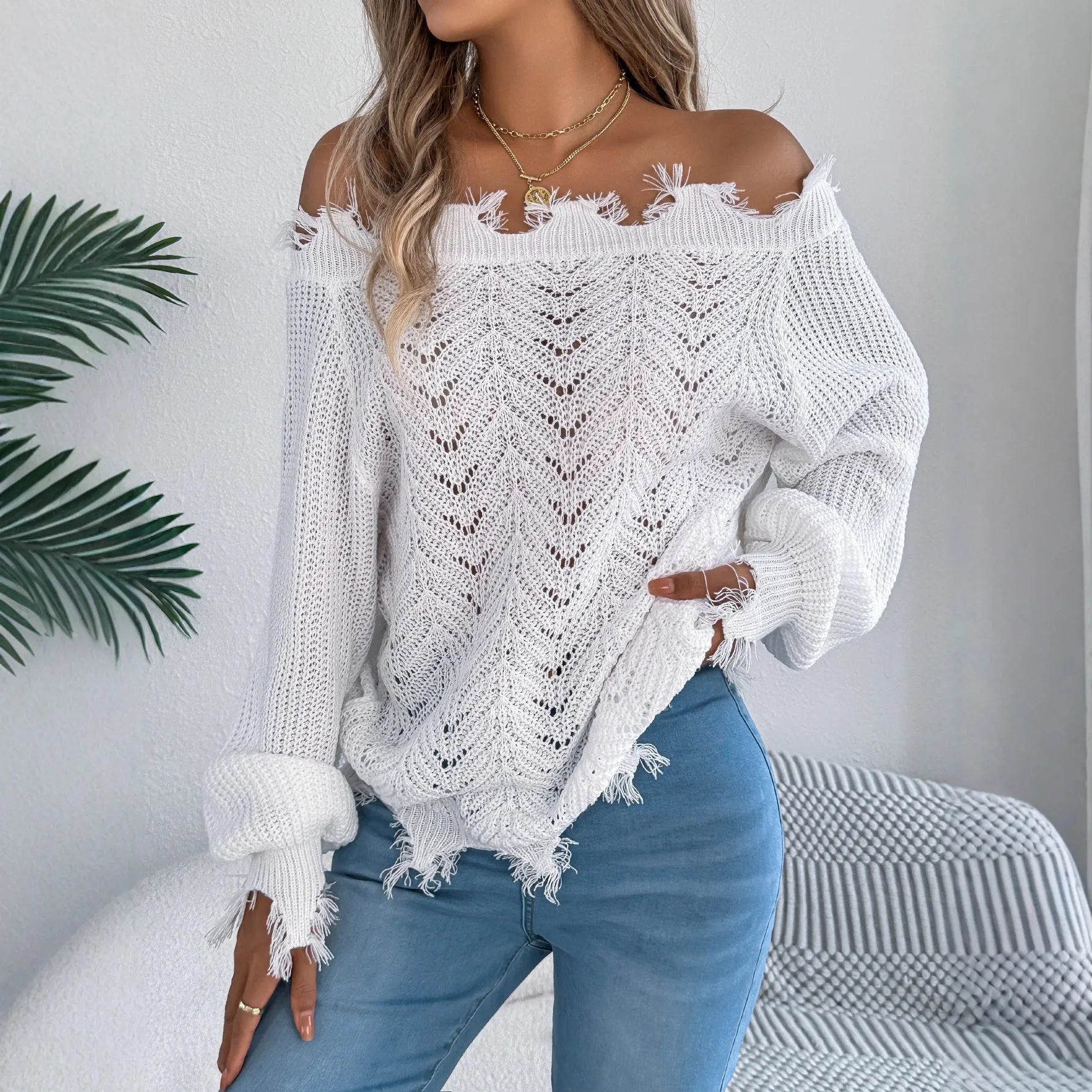 Women's white hollow-out cut-off-shoulder pullover sweater with regular sleeves on hanger