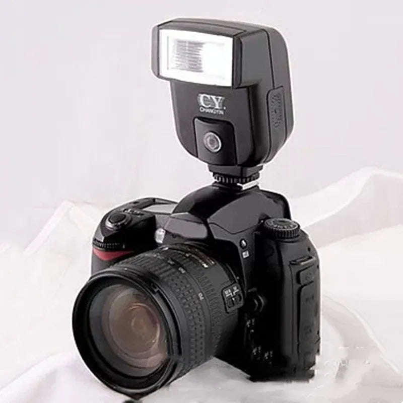 Compact black hot shoe camera flash unit with a head rotated upwards for bounce lighting.