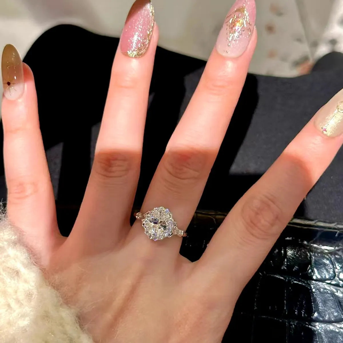 Silver adjustable diamond ring with geometric ellipse shape on finger