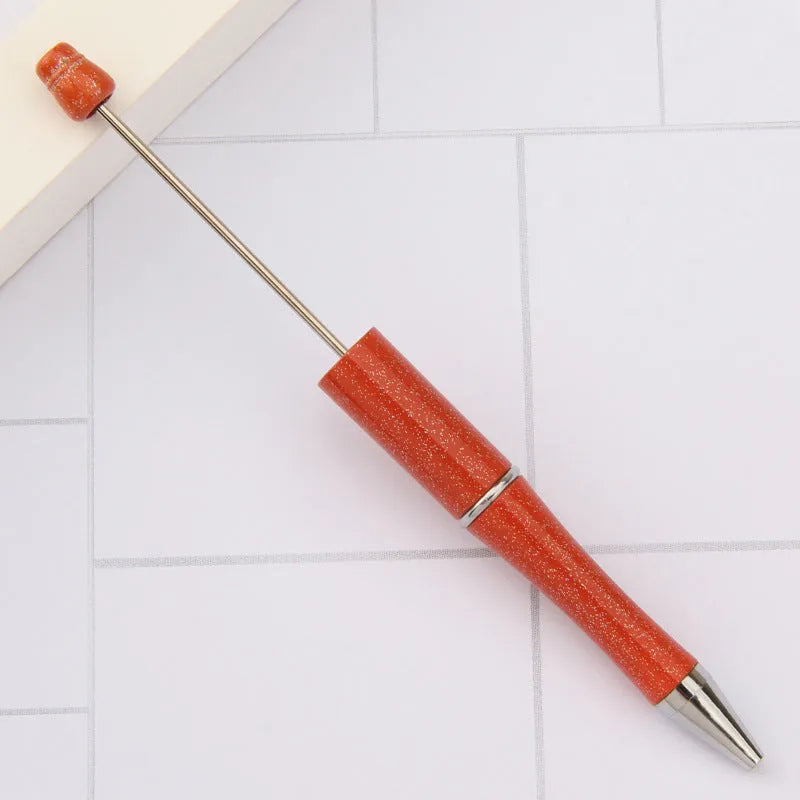 Ballpoint pen with colourful spinning plastic beads on barrel, shown in a gradient purple finish.