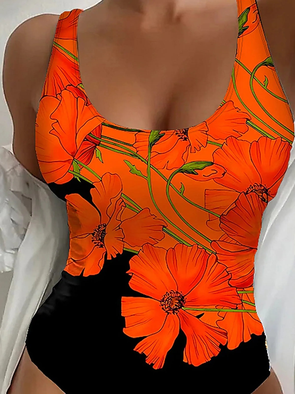 Orange floral print backless one-piece swimsuit on a model, showing slim fit design.