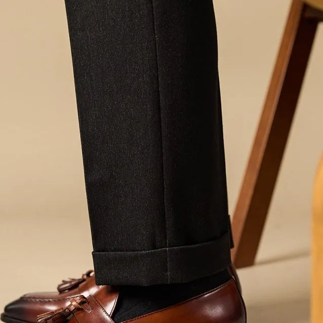 Men's black leather tassel loafers with rubber sole shown from side view