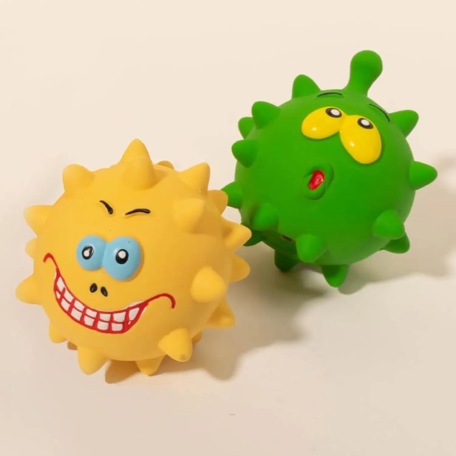 Four colourful natural latex rubber squeaky dog balls with cute faces measuring 7.5 cm