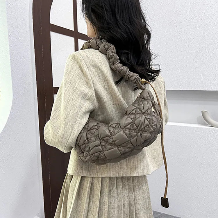 Women's solid colour nylon messenger bag with adjustable shoulder strap.