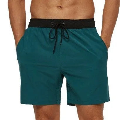 Men's blue drawstring shorts with stitched waistband and zippered pockets, shown for running and fitness use.