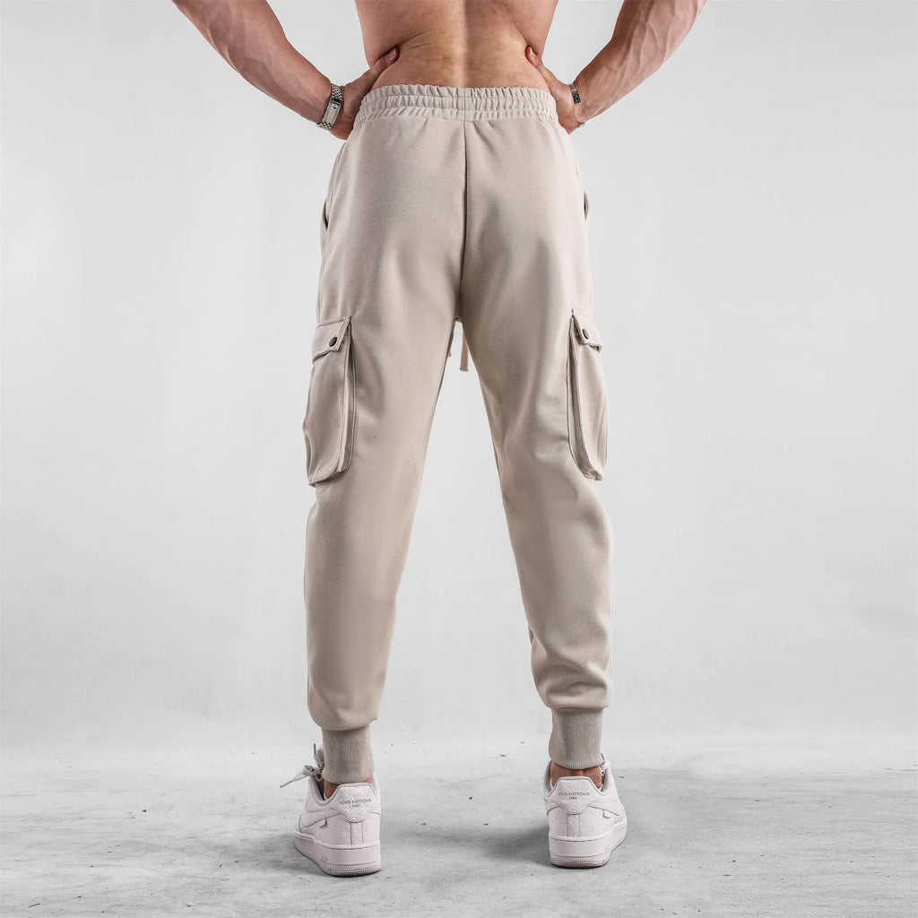 Men's loose cotton sports trousers with ankle tie closure and multiple pockets in solid colour