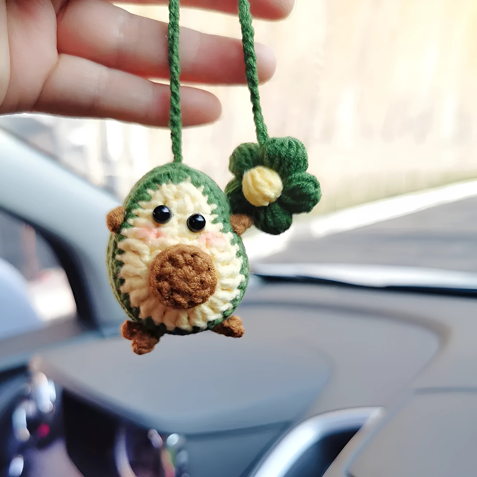 Handmade crocheted wool car pendant in avocado colour with rainbow flower design