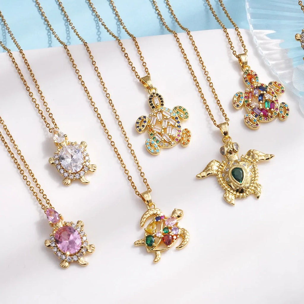 Gold-plated copper sea turtle necklace with zirconium-encrusted inlay on a titanium steel O-link chain