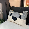 Grey schnauzer cartoon design pet pillow cushion on a sofa.