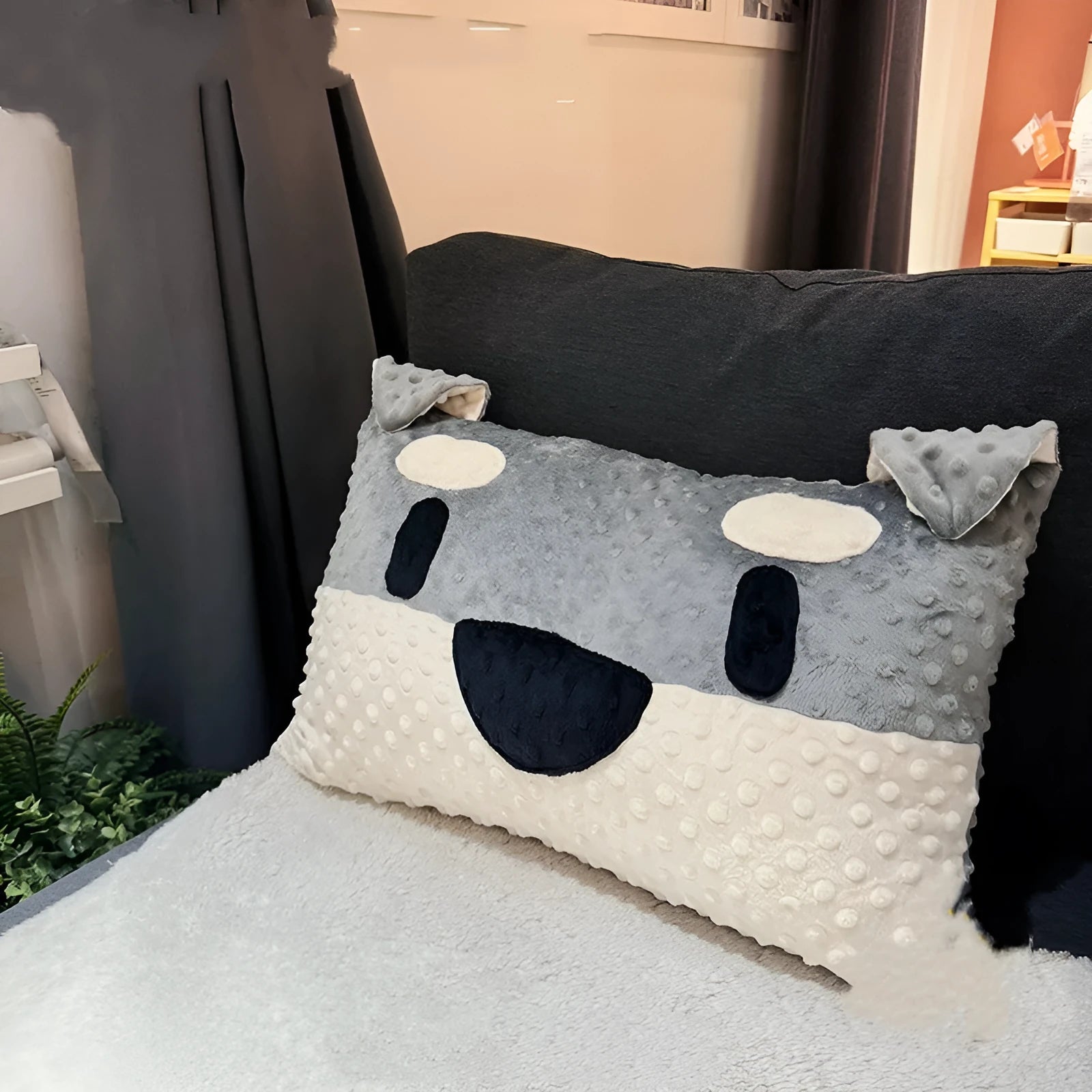 Grey schnauzer cartoon design pet pillow cushion on a sofa.
