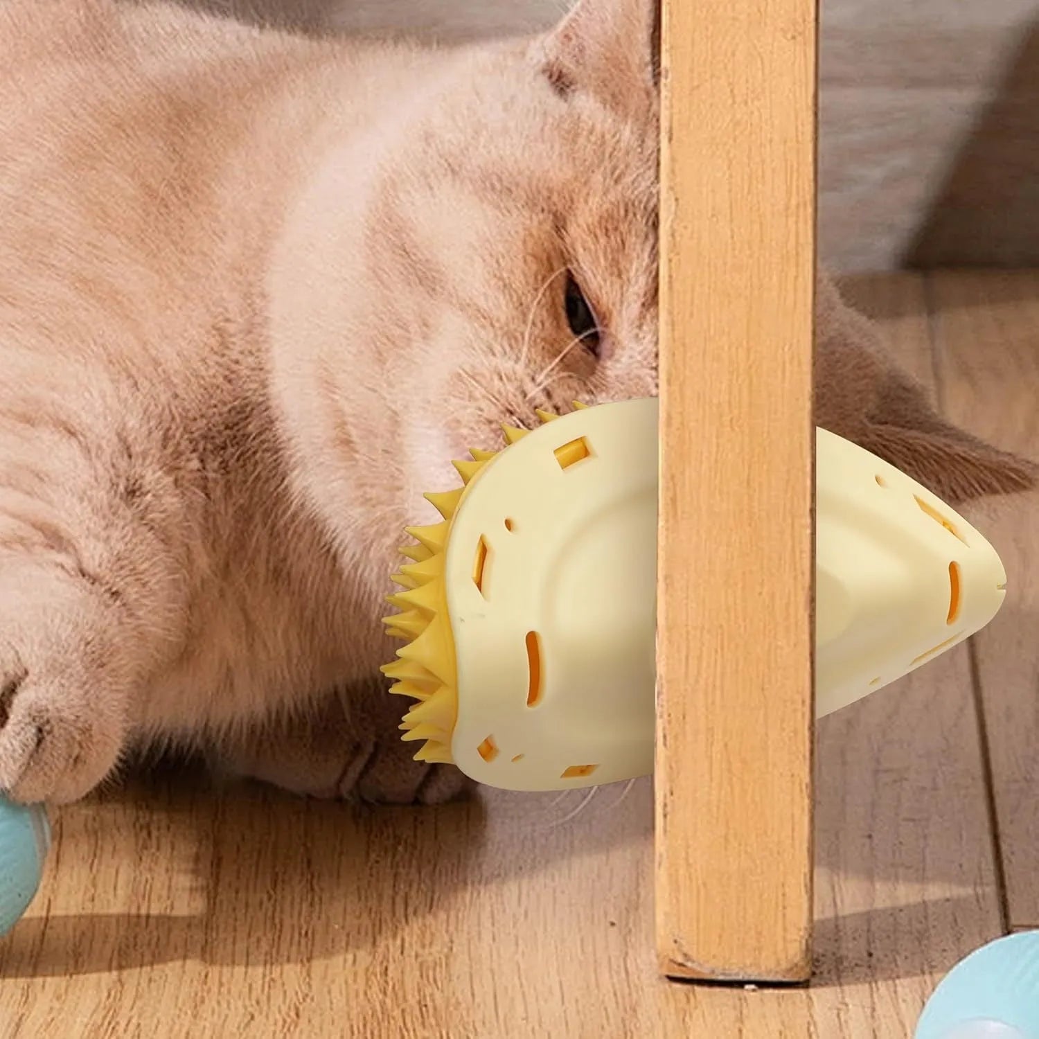 Yellow durian-shaped cat corner scratcher and grooming comb toy with peppermint powder.