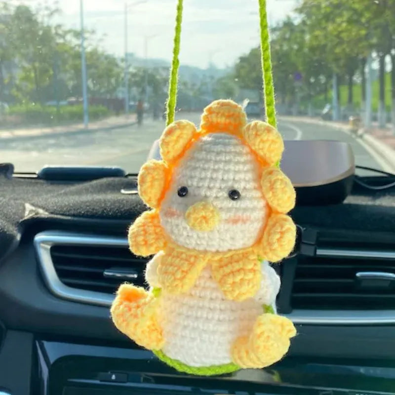 Green and white knitted wool car plant decoration with plastic base and hanging rope