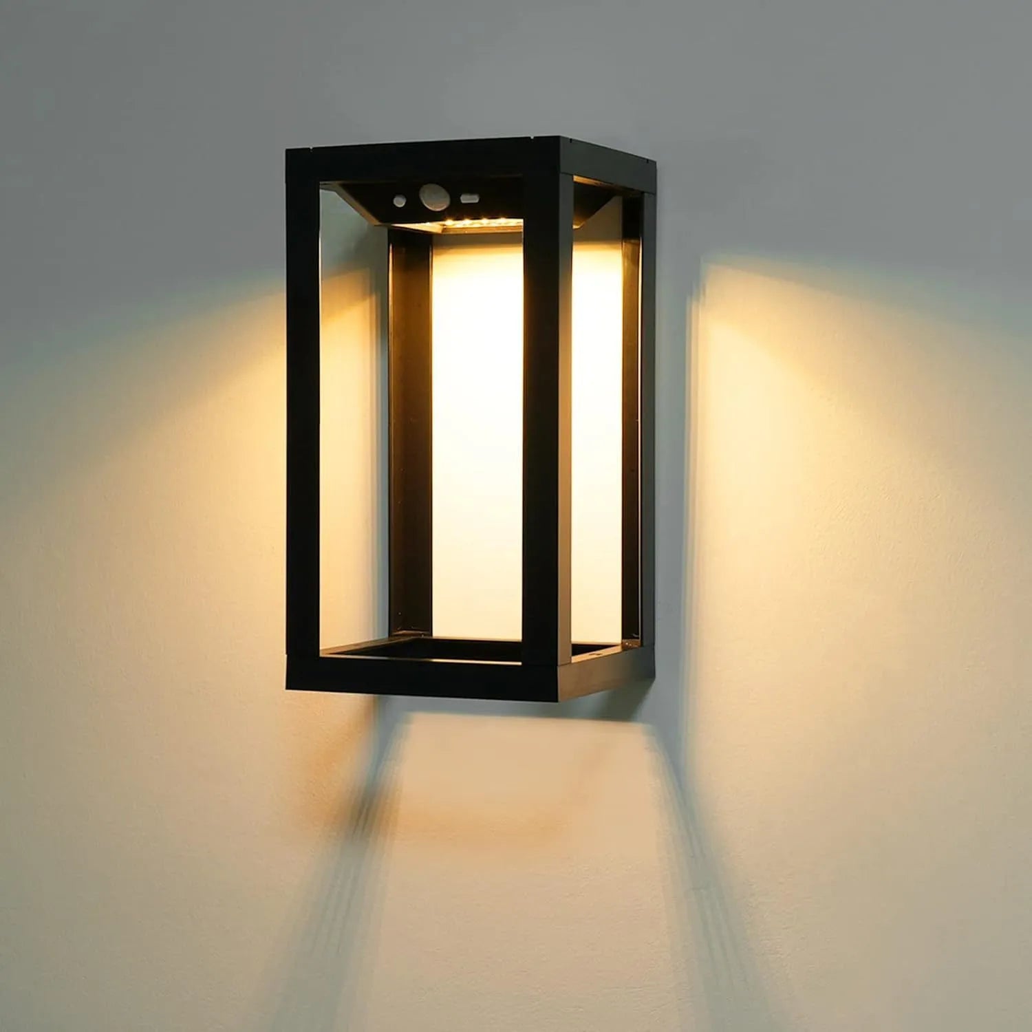 Modern Chinese-style outdoor solar wall lamp with plastic shell, shown in a garden setting.