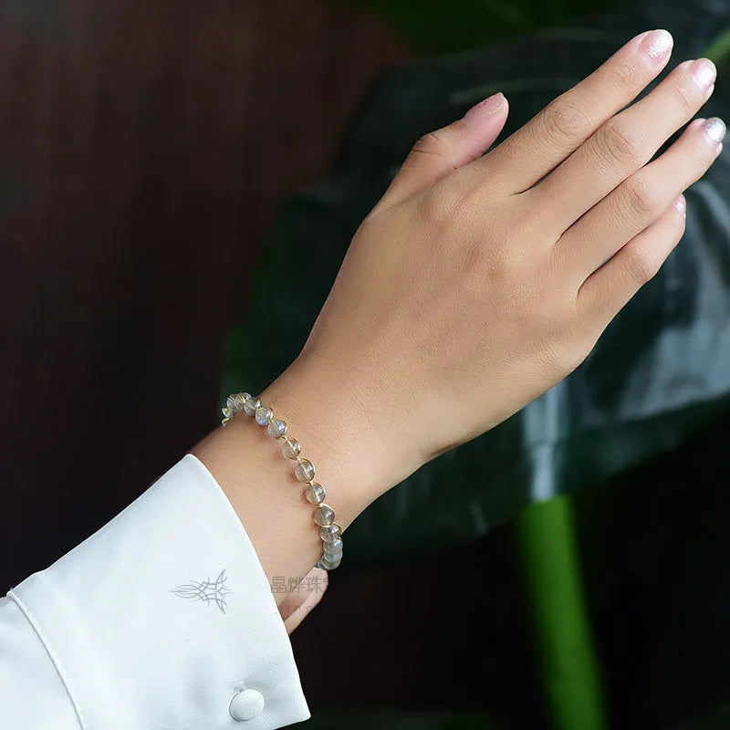 Women's bracelet with blue moonstone beads and gold-gilded metal in a starry sky design.