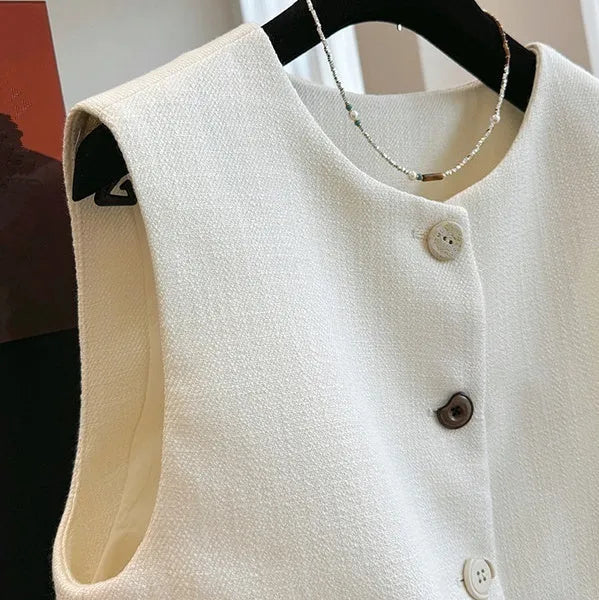 Sleeveless bandage dress vest with round neck in milky white or black polyester fabric.