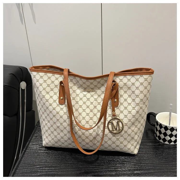 PU leather shoulder bag with sewing thread detail in black colour showing 42cm width and structured design