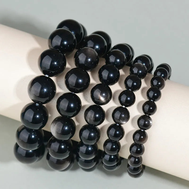 Hand-woven obsidian crystal bracelet couple set showing six colour variations with round beads