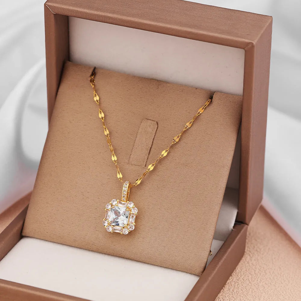 Gold geometric zircon inlaid pendant on a water wave chain necklace.