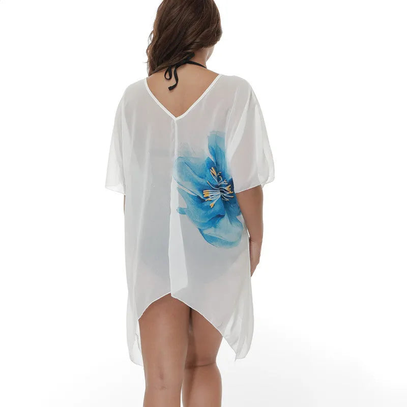 A white, loose-fitting plus size beach cover-up blouse for swimming and sun protection.