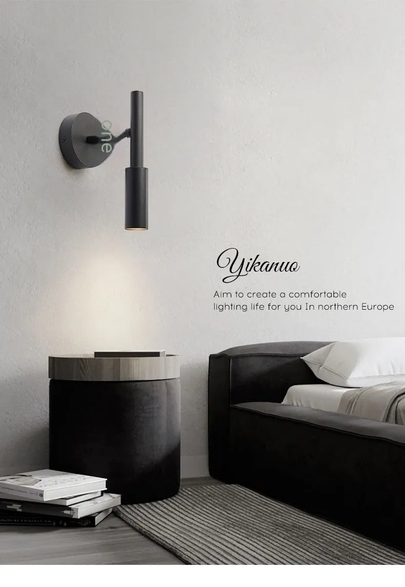 Modern cylindrical wrought iron wall lamp in black or white with three colour light settings.