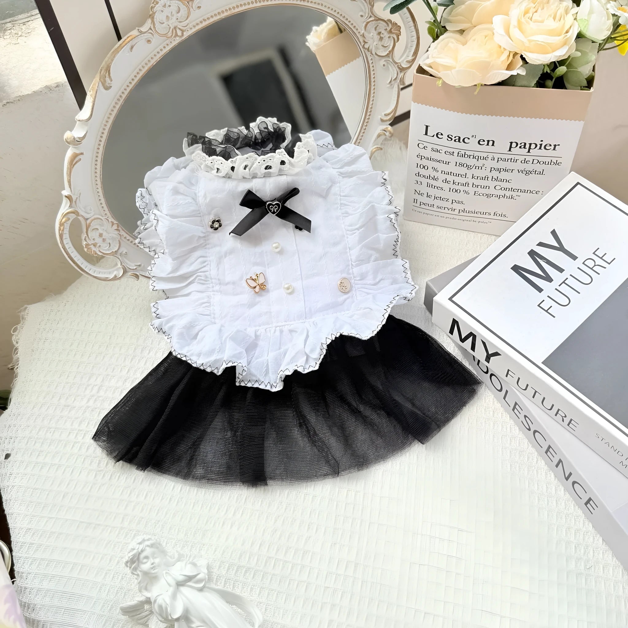 White polyester princess style gauze skirt for a small dog on a hanger, showing the layered skirt design.