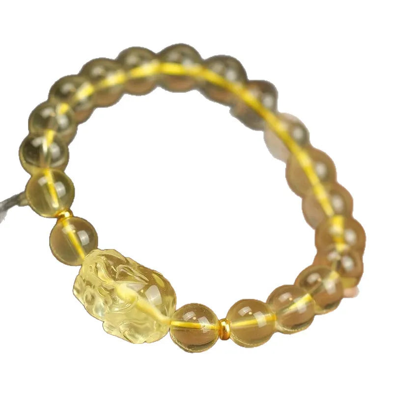 Yellow leather bracelet with an artificial citrine Pi Xiu charm in simple Chinese style.