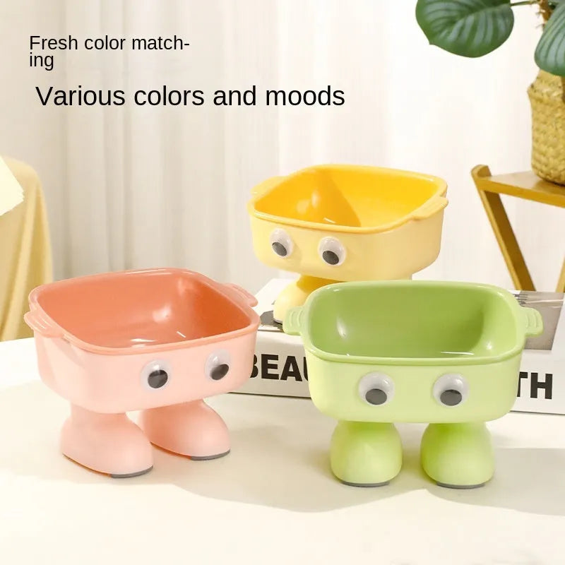 Green robot-shaped elevated cat bowl with tilted design and non-slip base