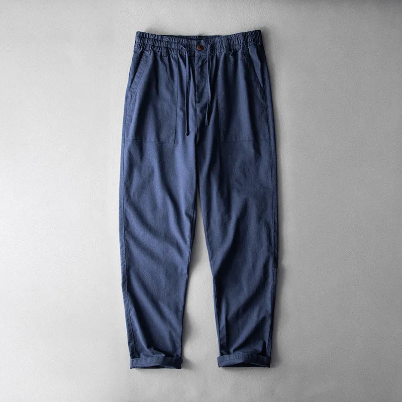 Men's linen casual trousers in a solid colour, shown in navy blue, apricot, and grey options.