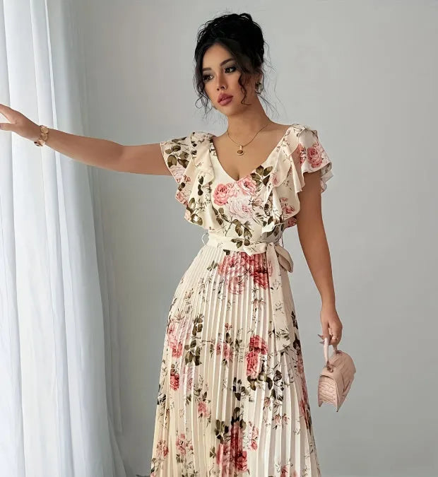 Apricot coloured floral print dress with V-neck, ruffled short sleeves, and a high-waisted oversized swing skirt.