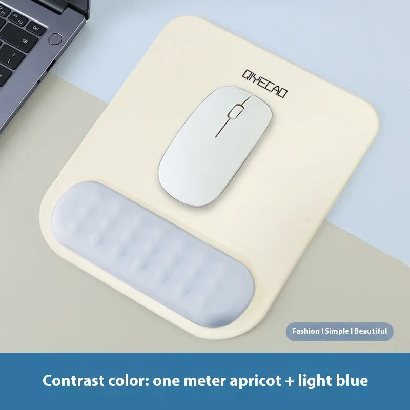 Ergonomic cloth-silicone mouse pad with raised wrist support on a desk