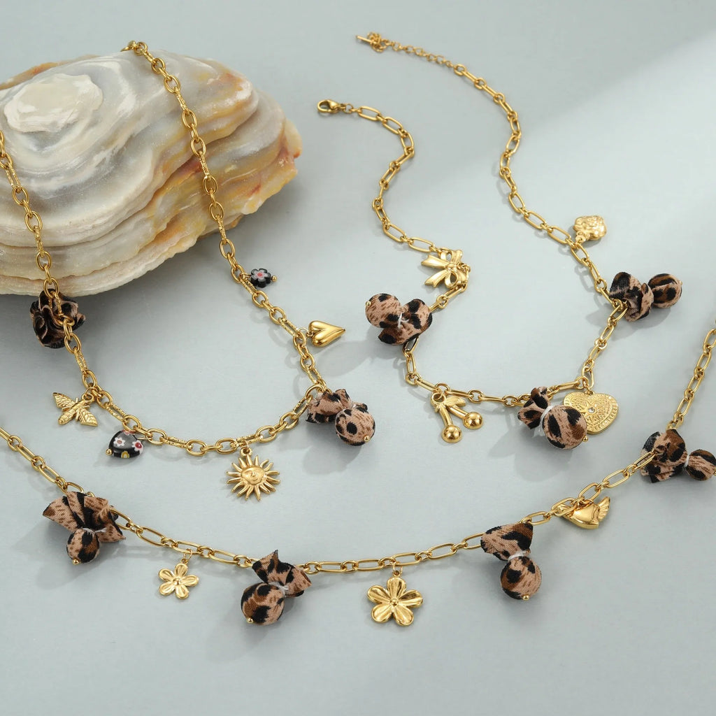 Women's stainless steel necklace with leopard, love heart, and flowers pendant on a regular chain.