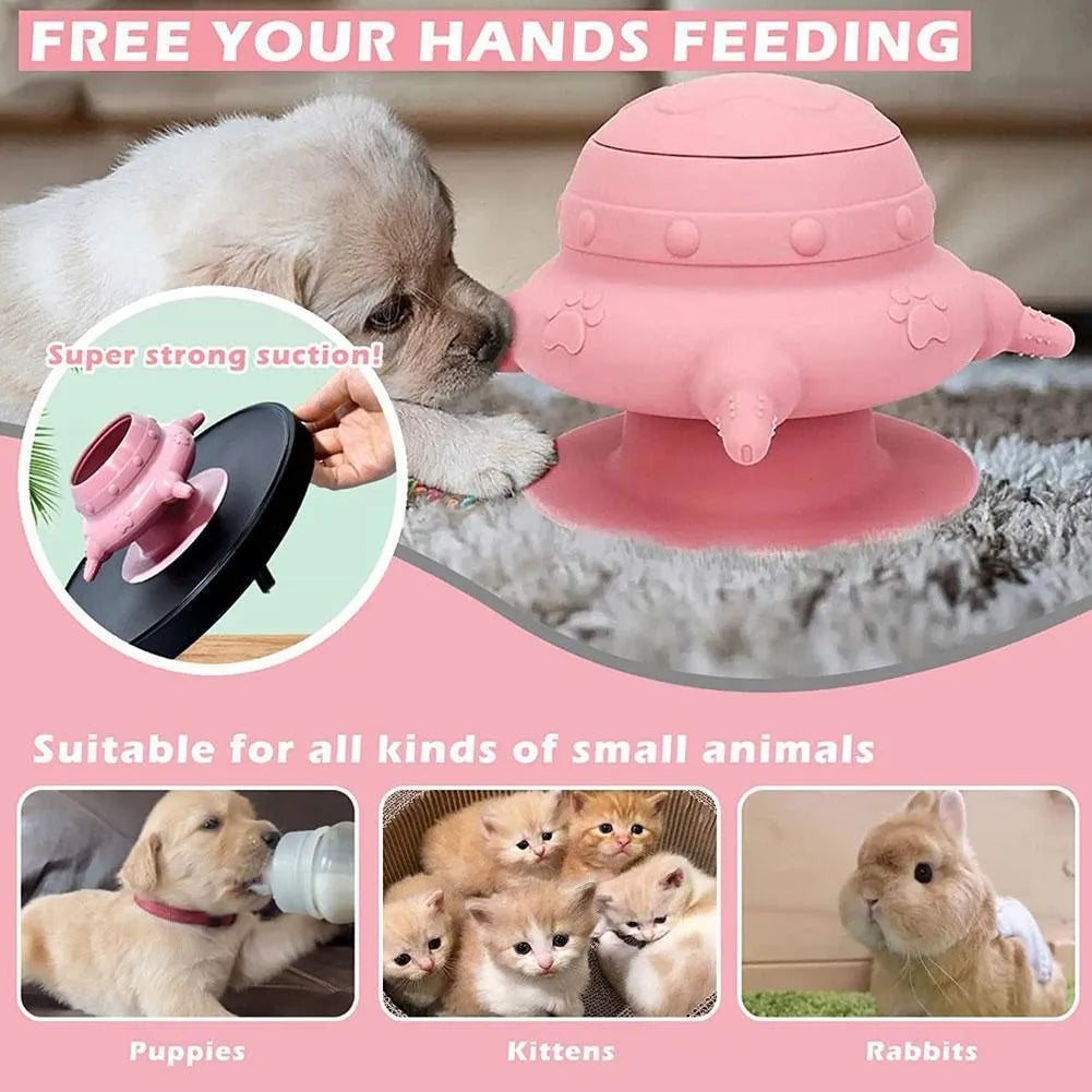 Pink silicone pet nursing device with milk bowl and four pacifiers for puppies and kittens on a flat base.