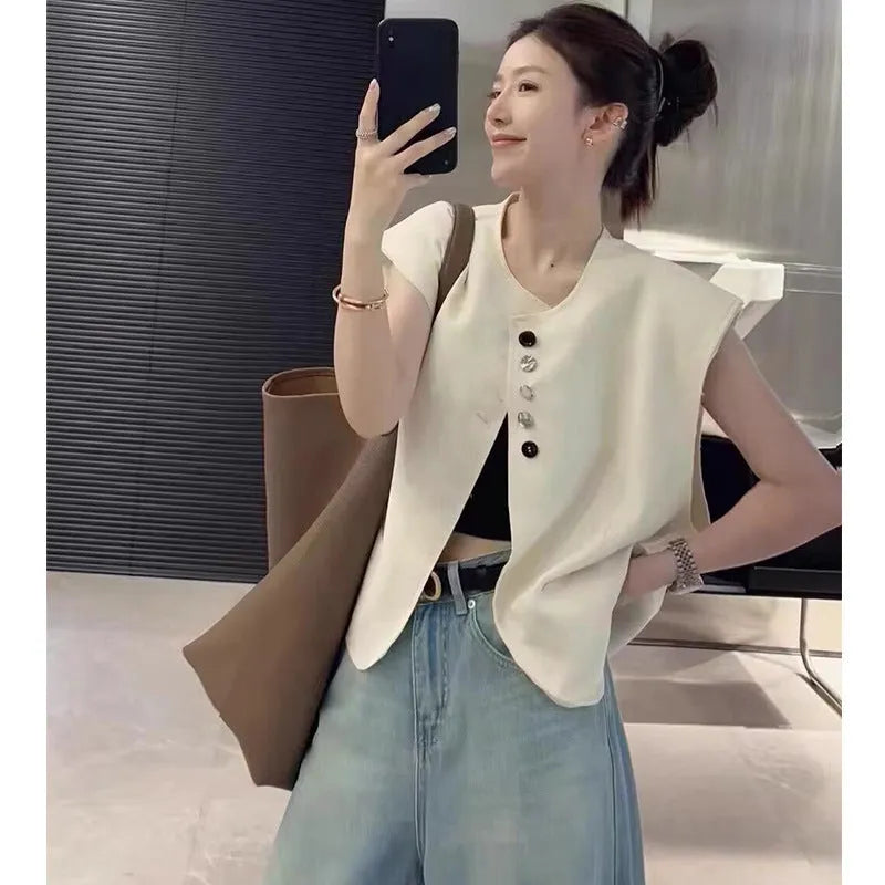 Women's short-length polyester vest in milky white, showing loose fit and front pockets